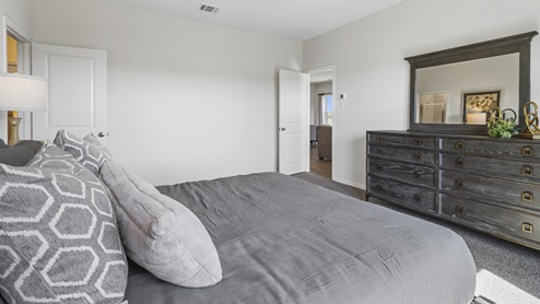Large Primary Bedroom with large window and furnishings