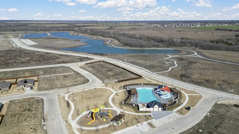 Aerial photo of large swimming pool, playground, fishing pond and walking trails