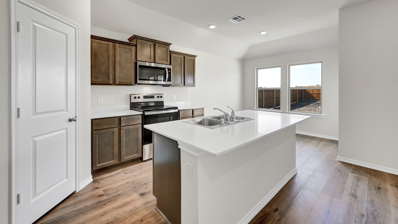 X40A kitchen with white countertops and brown cabinets