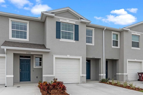 Attached townhome with concrete block construction and a one-car garage.