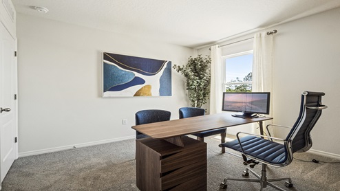 Functional home office with desk, chairs and space to work or play.