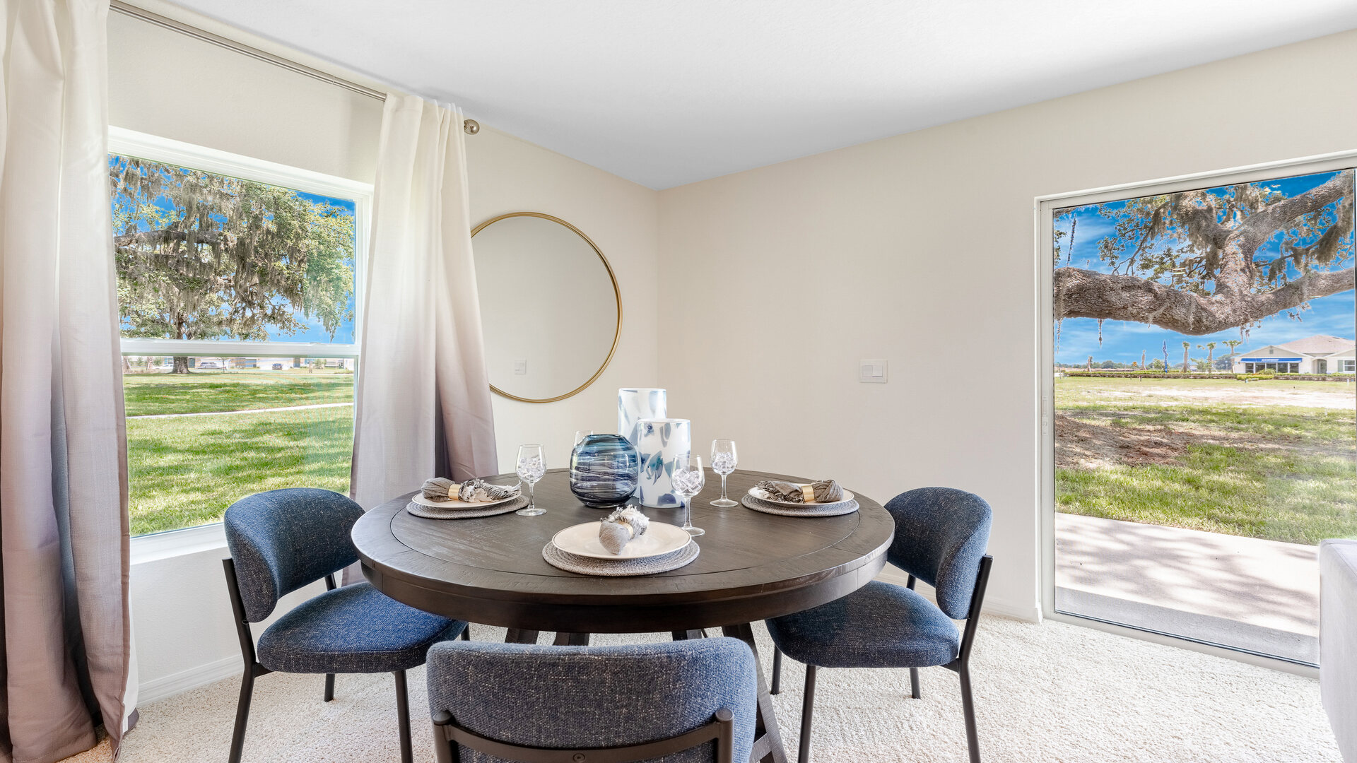 Dining room adjacent to the kitchen with table, chairs and tile flooring.