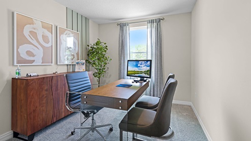 Functional home office with desk, chairs and space to work or play.