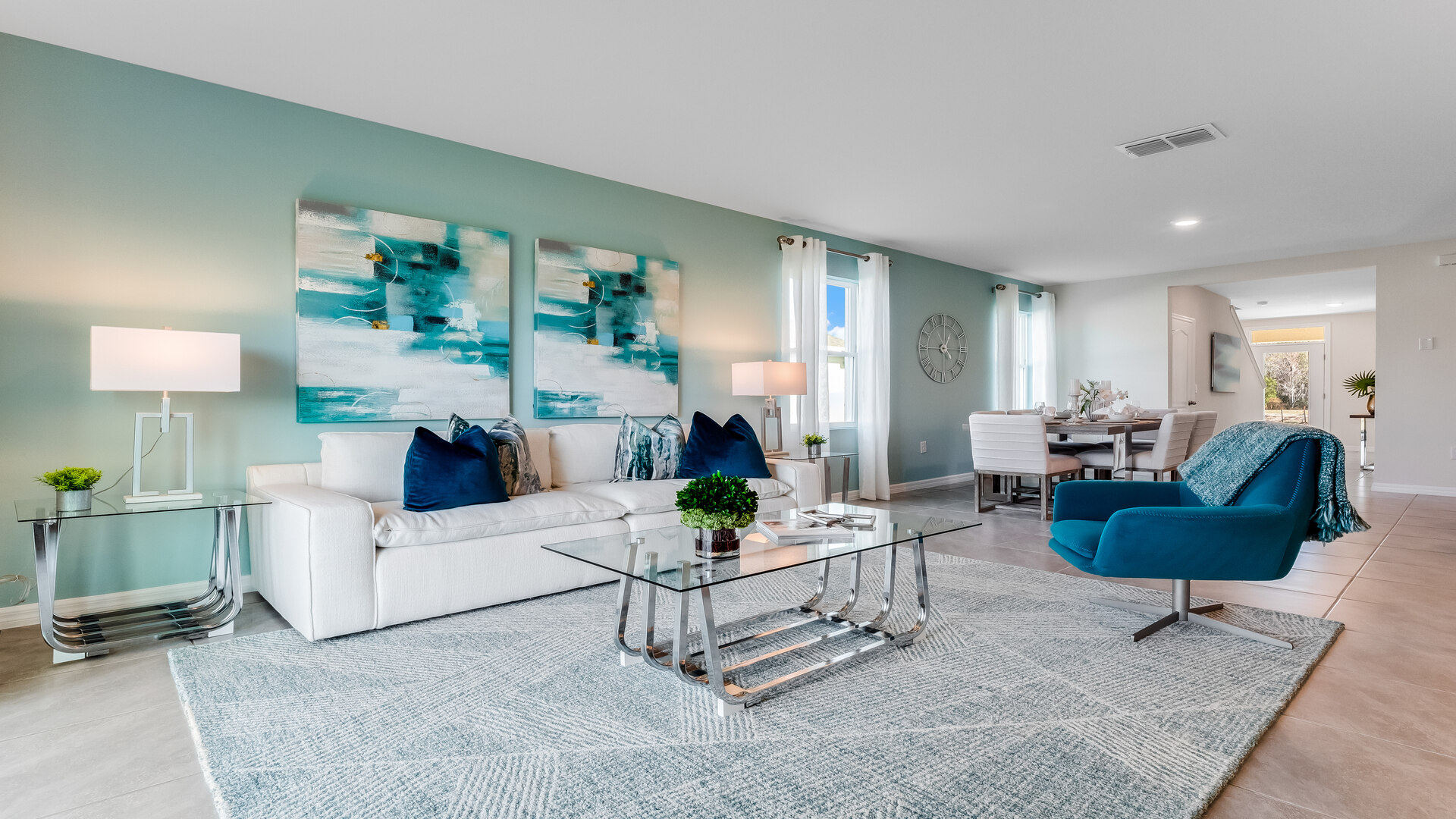 Open concept living area with couch seating and access to the backyard thru slider door.