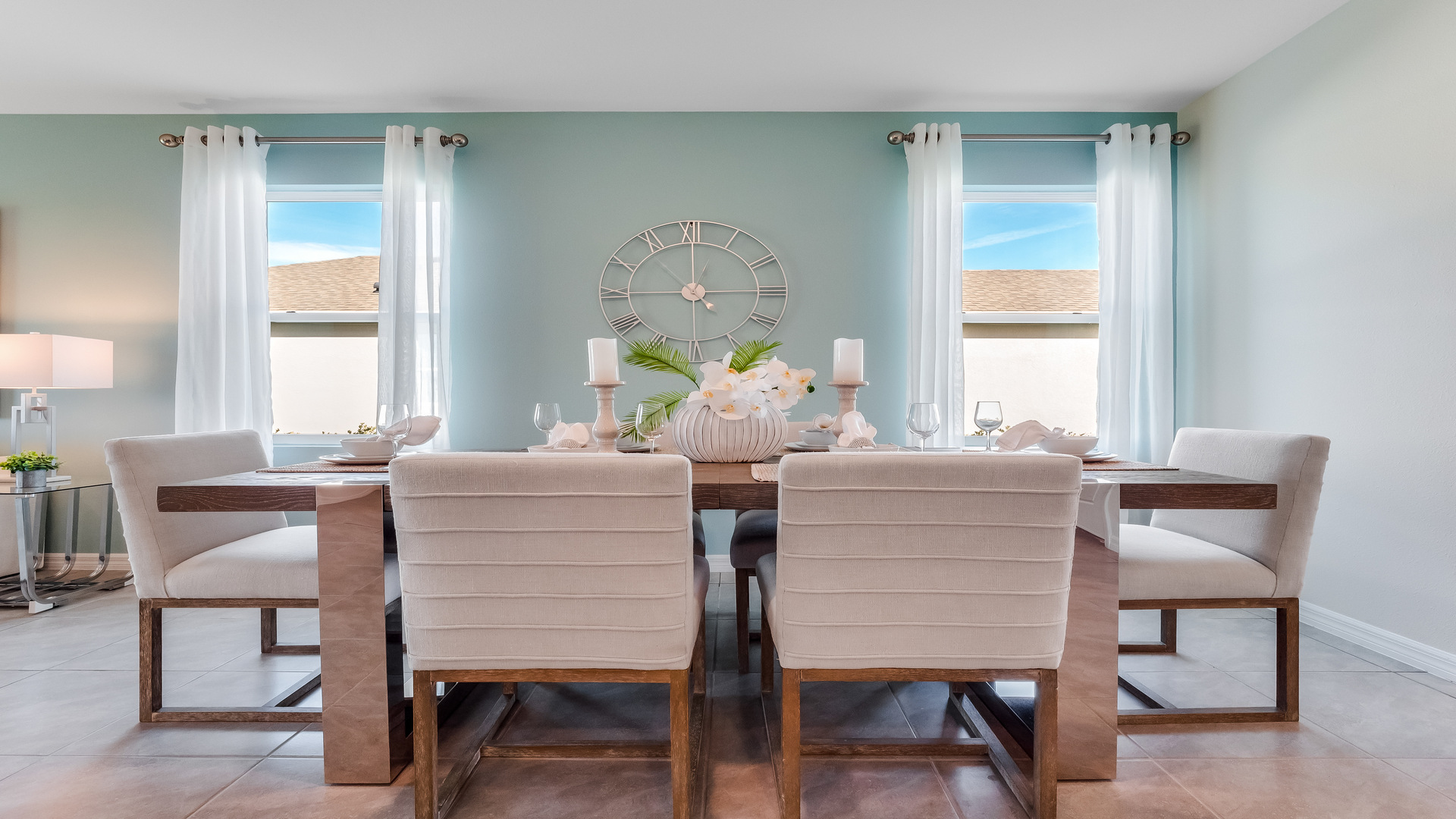 Dining room adjacent to the kitchen with table, chairs and tile flooring.
