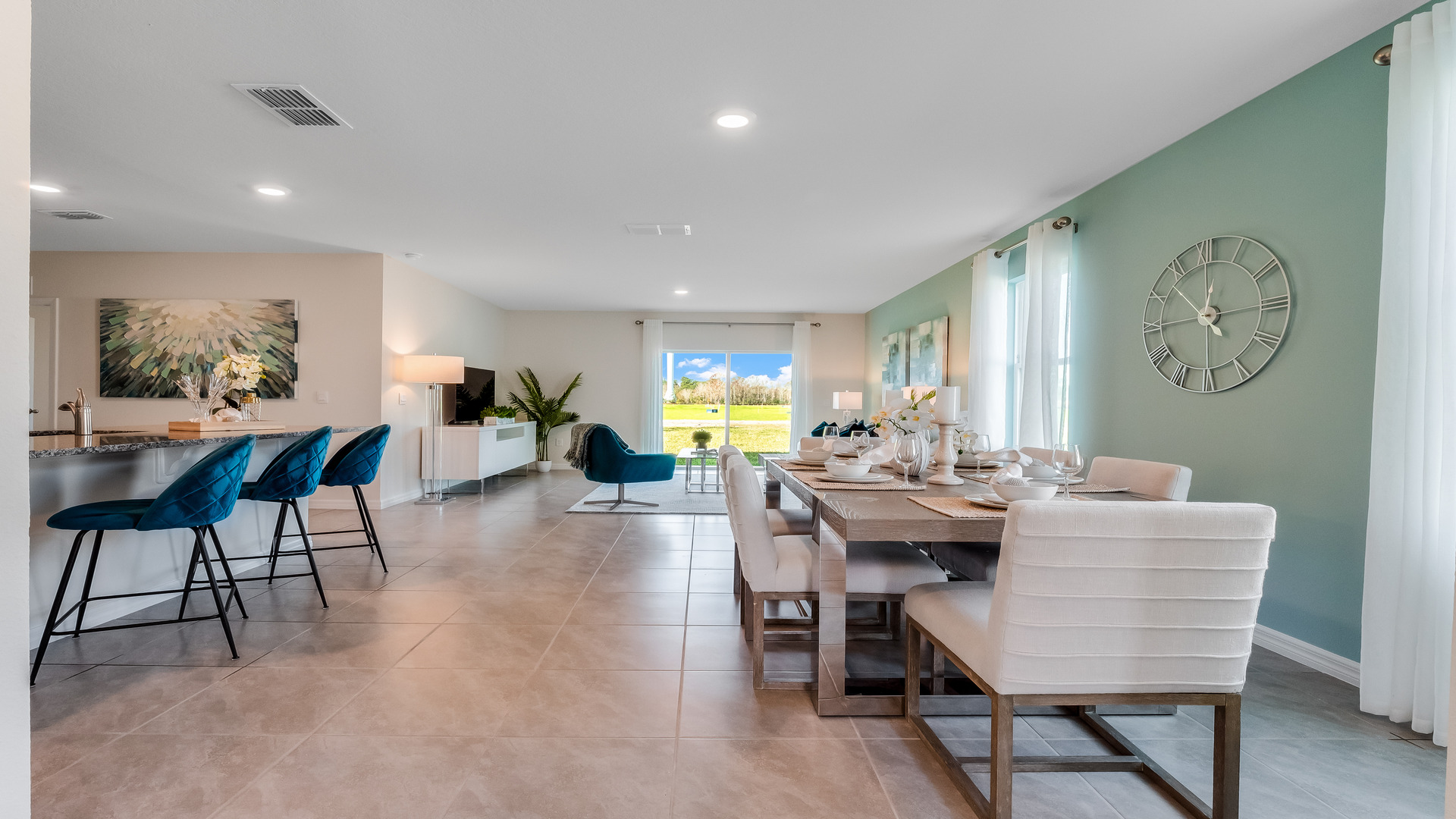 Dining room adjacent to the kitchen with table, chairs and tile flooring.