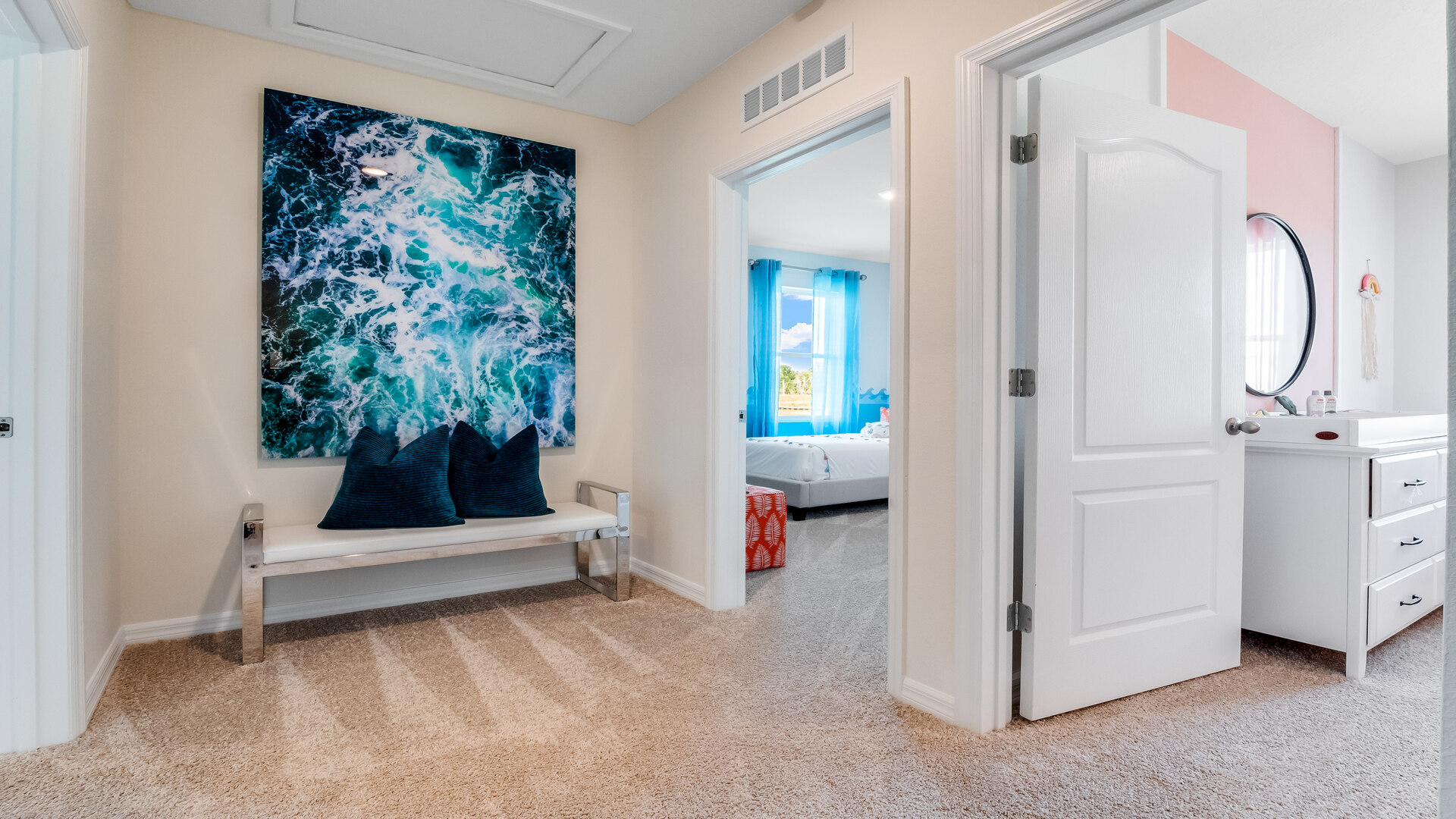 Child's nursery with crib, closet, soft seating and storage.