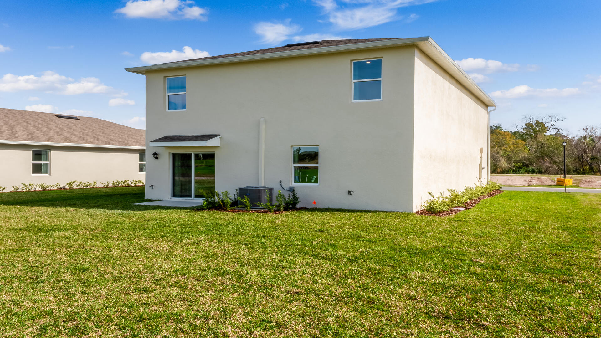 Home backyard with covered lanai, and room for entertaining.