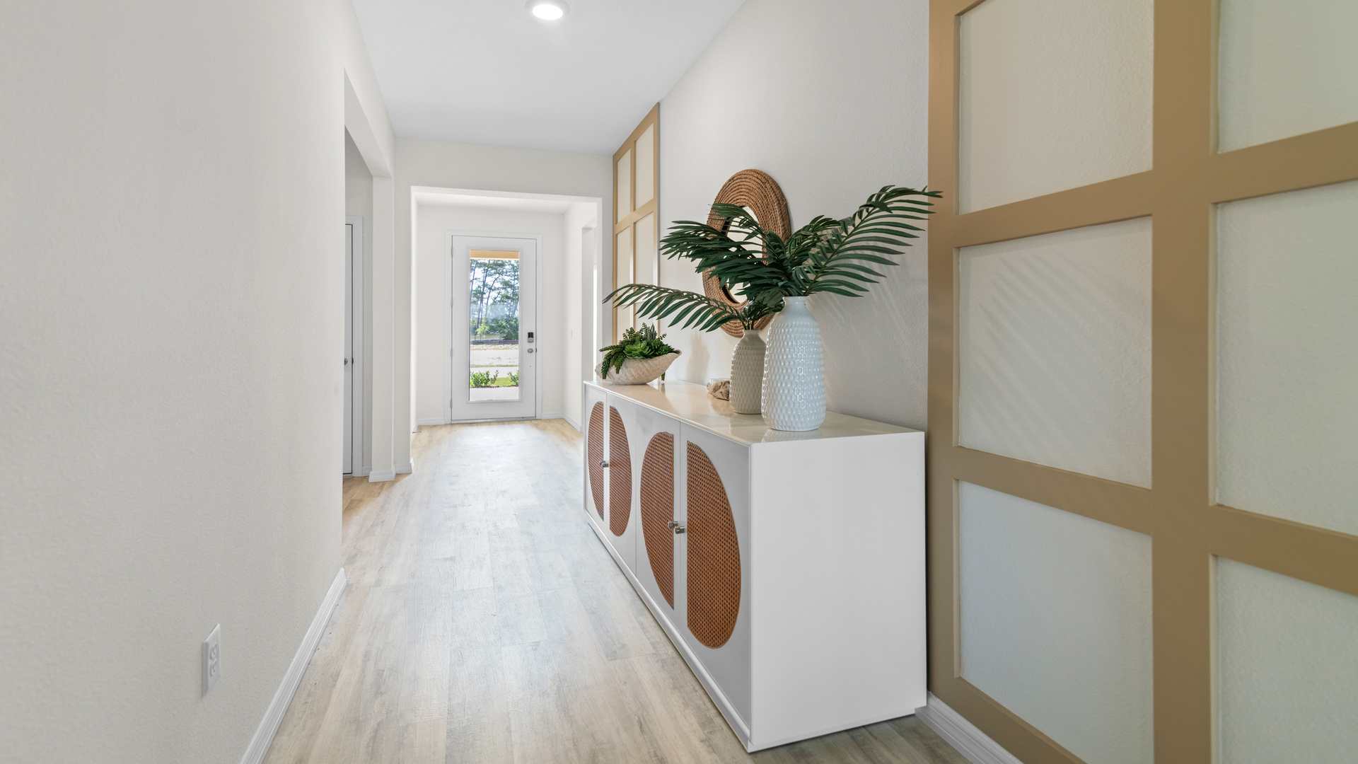 Home entry way thru the front door with tile flooring and a view to the living space.