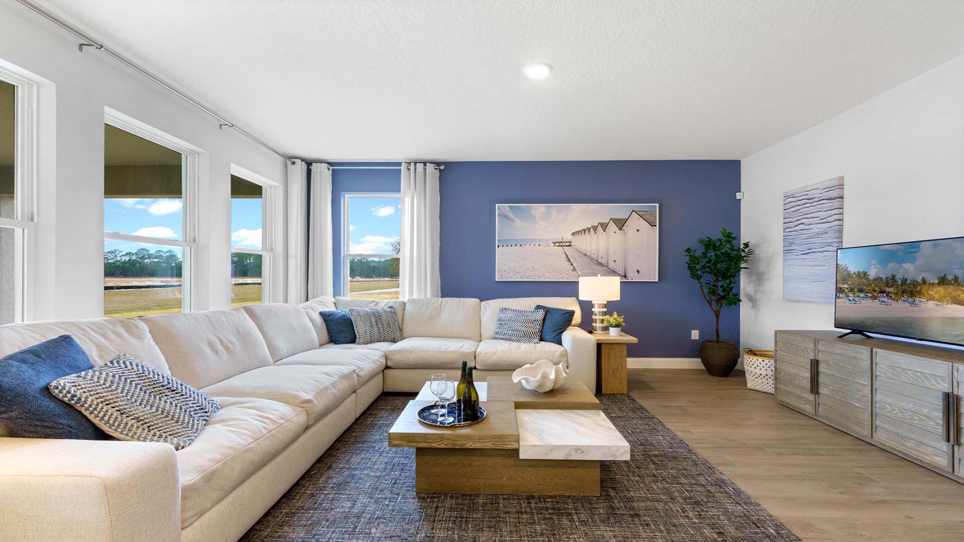 living room area with lots of windows and couch with coffee table