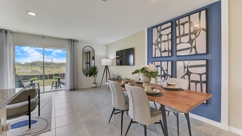 Dining area for small table and some chairs with sliding glass door for natural lighting.