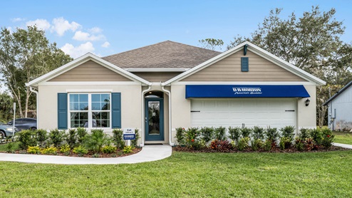 Single story new home with siding, covered porch and 2 car garage.