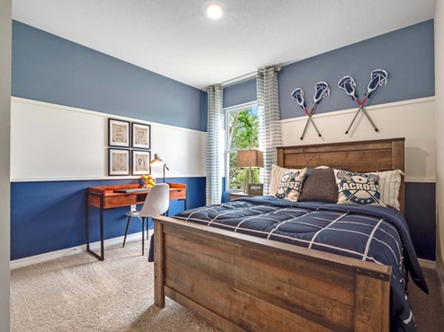 Childs bedroom with colorful décor and bedding and furniture for storage.