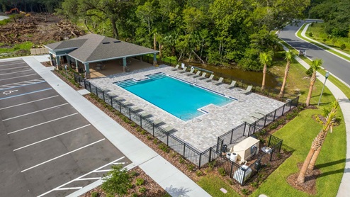 Sunny day at the community swimming pool with lounge seating.