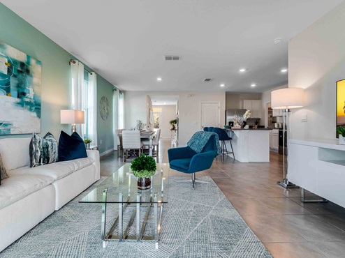 Dining room adjacent to the kitchen with table, chairs and tile flooring.
