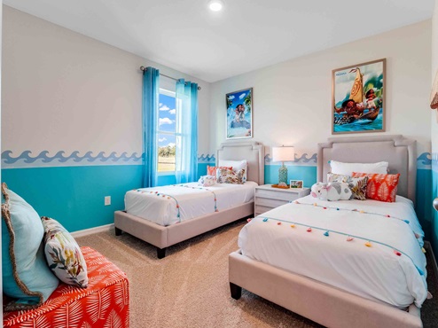 Childs bedroom with colorful décor, twin beds and furniture for storage.