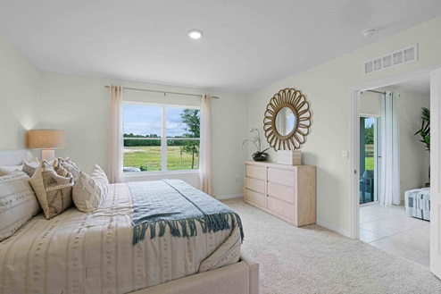 Open concept living area with couch seating overseeing kitchen.