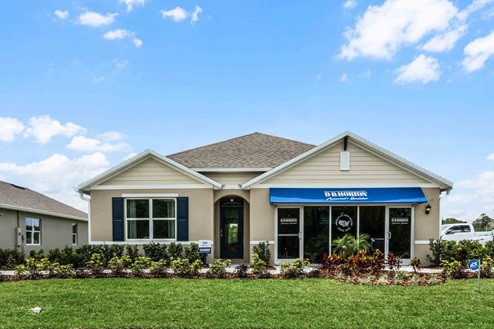 Single story new home with siding, covered porch and 2 car garage.
