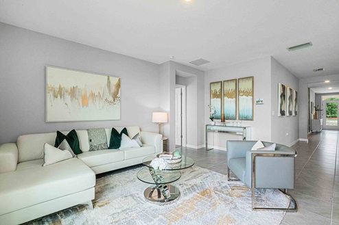 Open concept living area with couch seating overseeing kitchen.