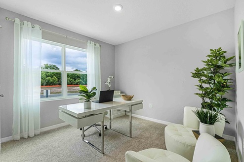 Functional home office with desk, chairs and space to work or play.