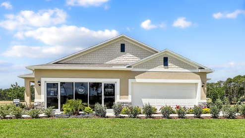 Single story new home with siding, covered porch and 2 car garage.