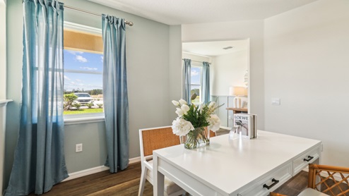 Functional home office with desk, chairs and space to work or play.