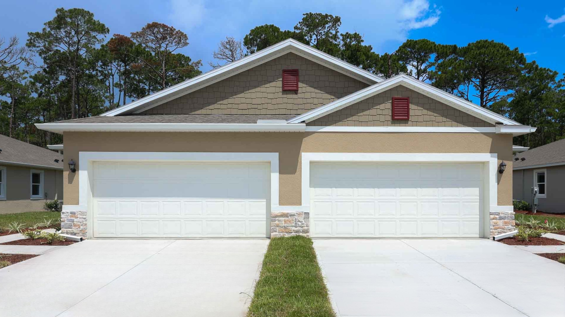 Single story new home with large windows and 2 car garage.