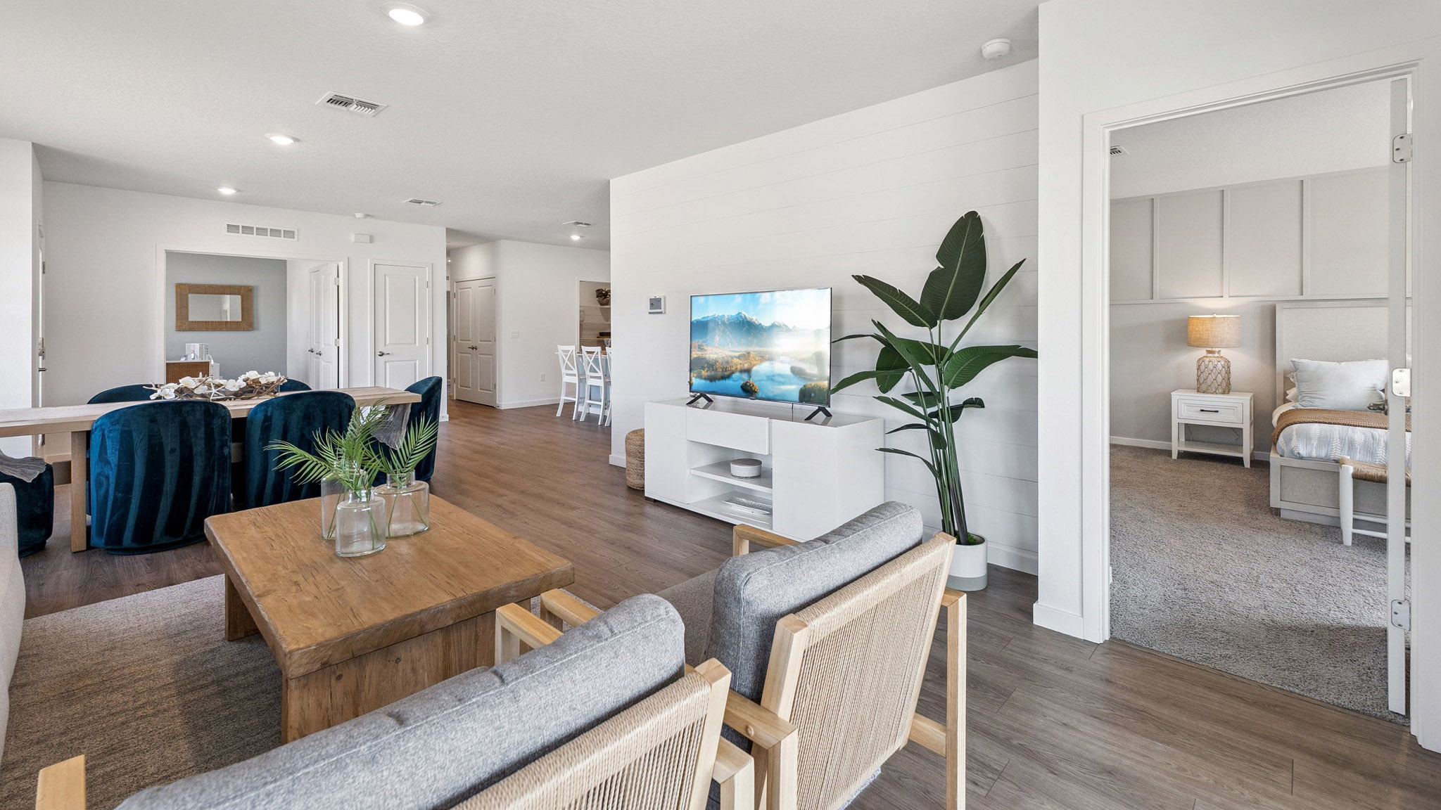 Living area with laminate Flooring and dining room table.