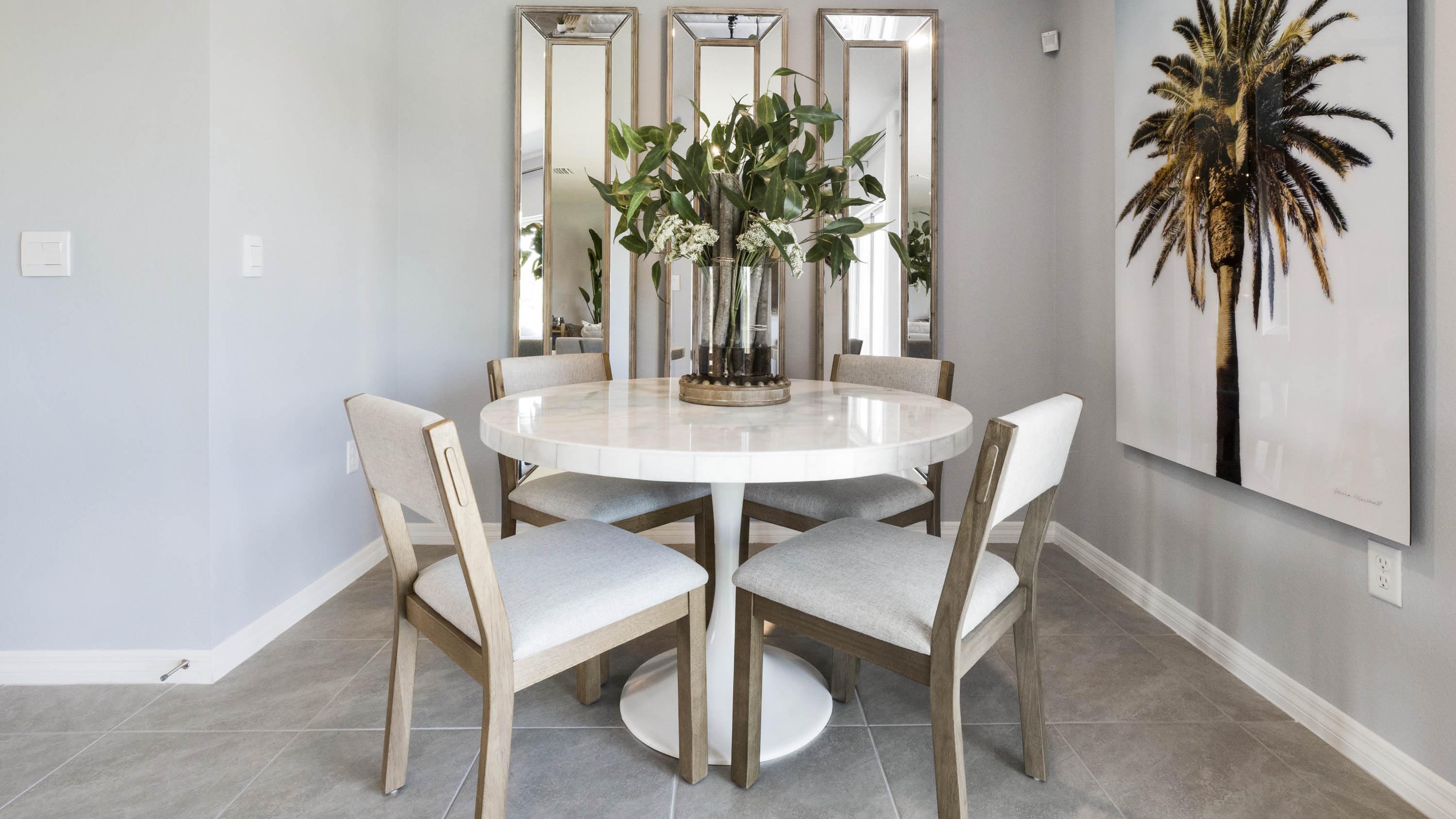 Dining room area with table, seating and natural lighting.