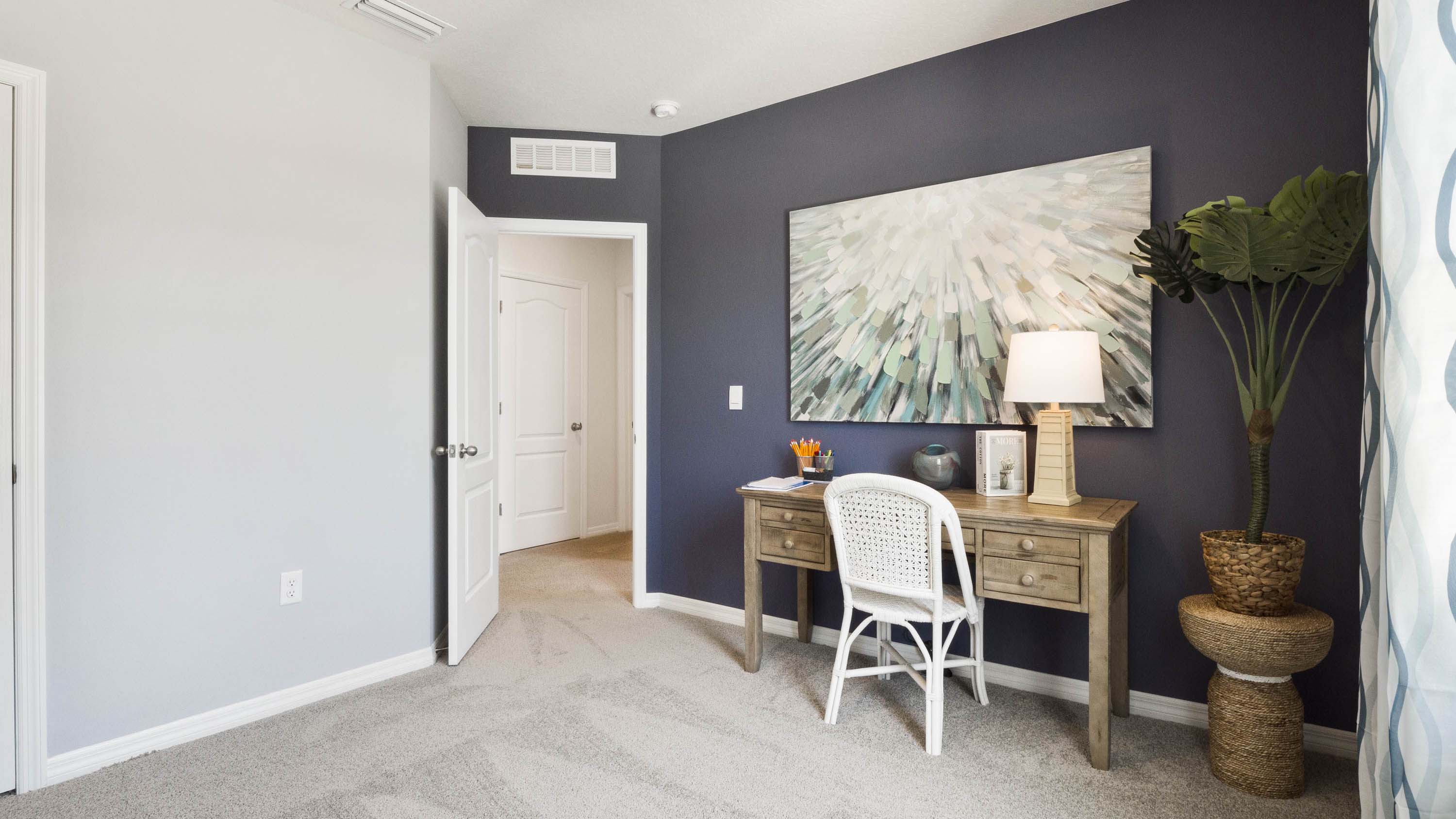 Functional home office with desk, chairs and space to work or play.