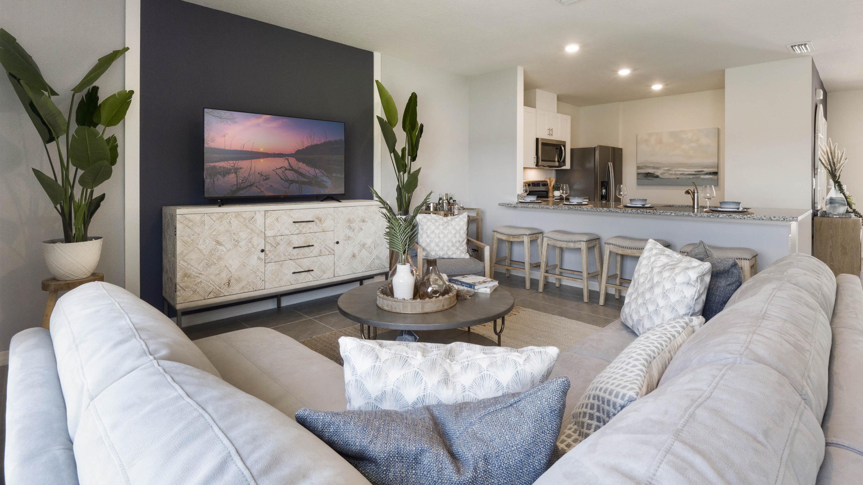 Living area with couch seating, entertainment system and natural lighting