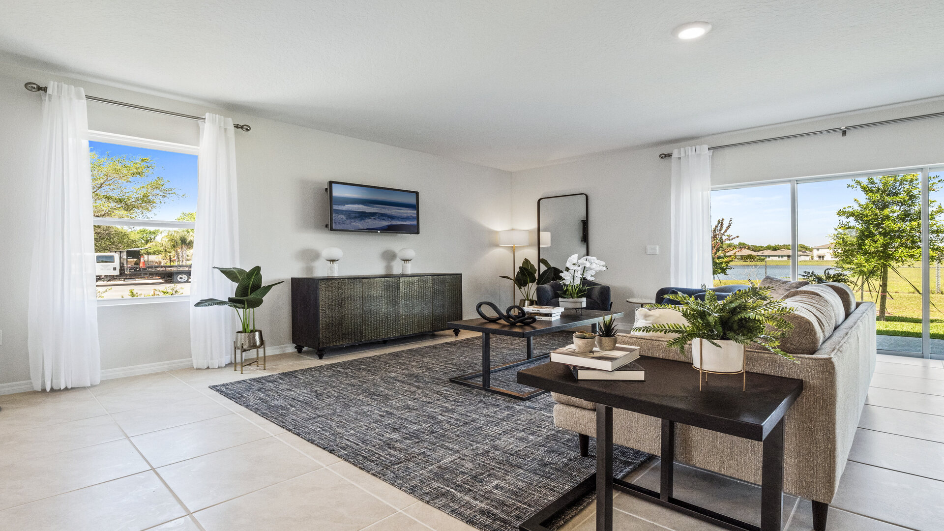Living area with couch seating, entertainment system and natural lighting