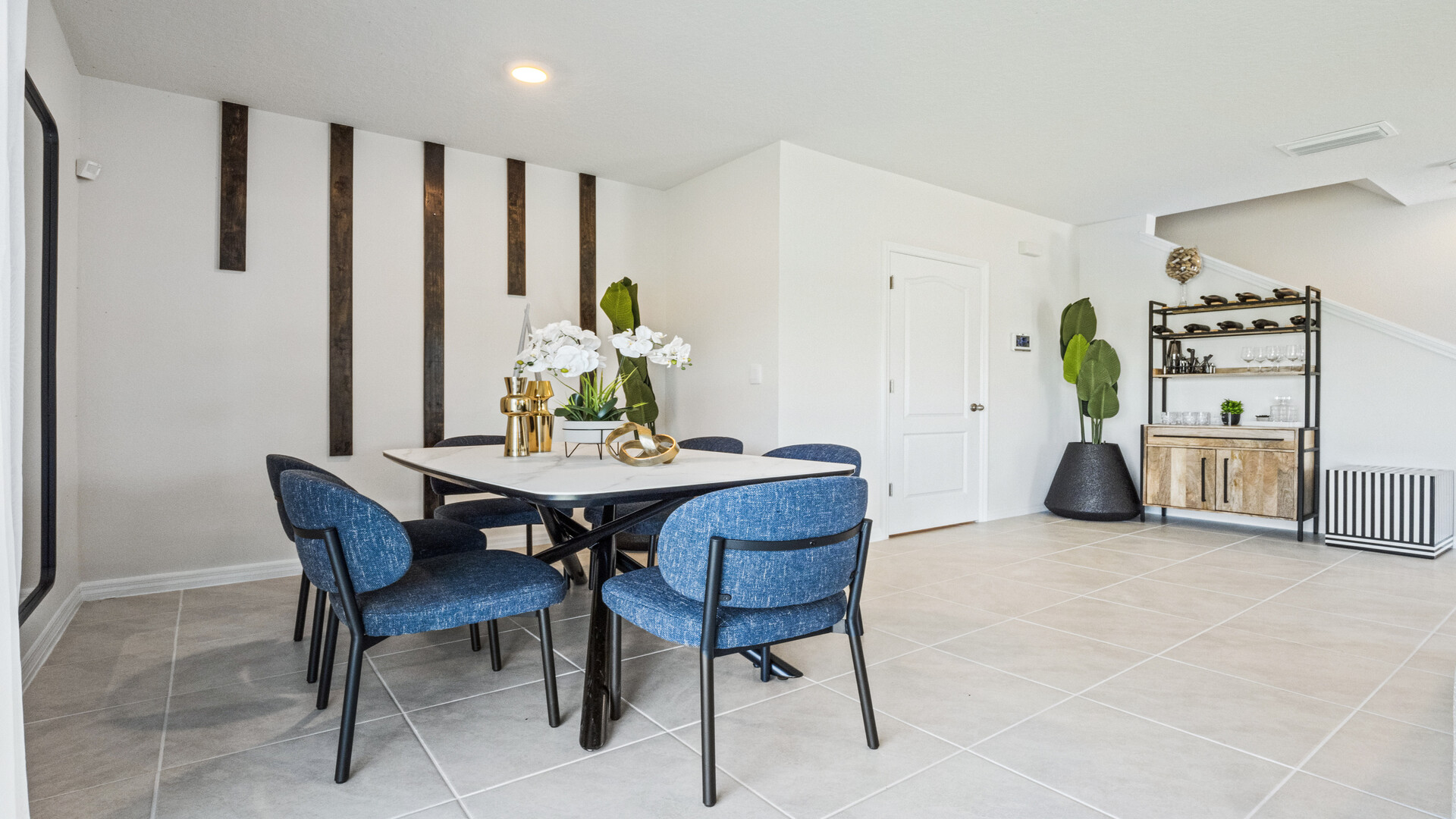 Dining room area with table, seating and natural lighting.