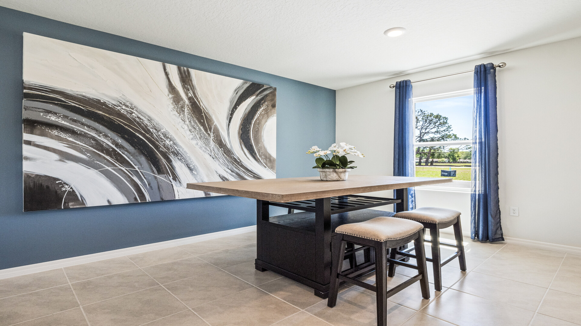 kitchen with quartz countertops overseeing living area and dining room table