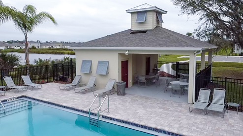 Pool cabana area with lounge seating, covered shaded areas and restrooms.