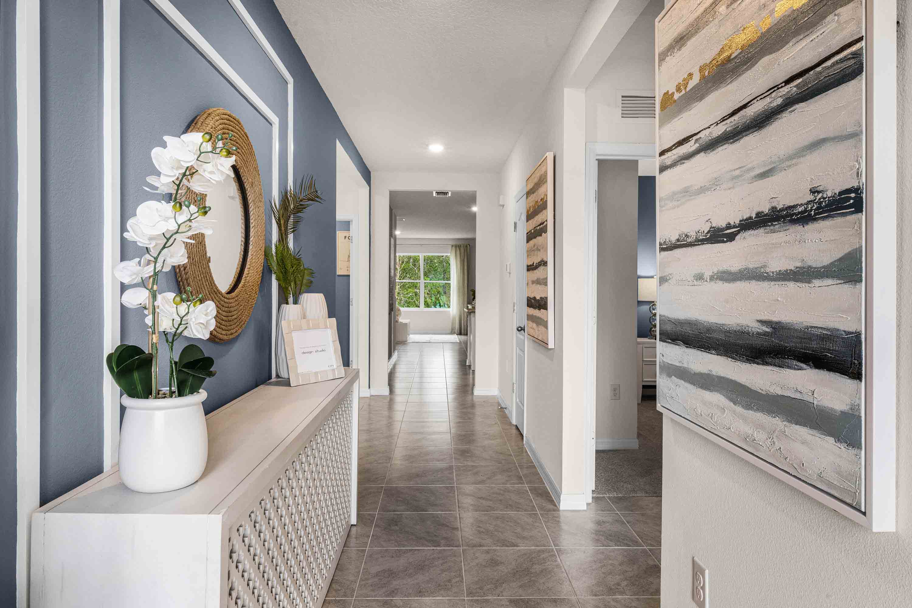 Home entry way thru the front door with tile flooring and a view to the living space.