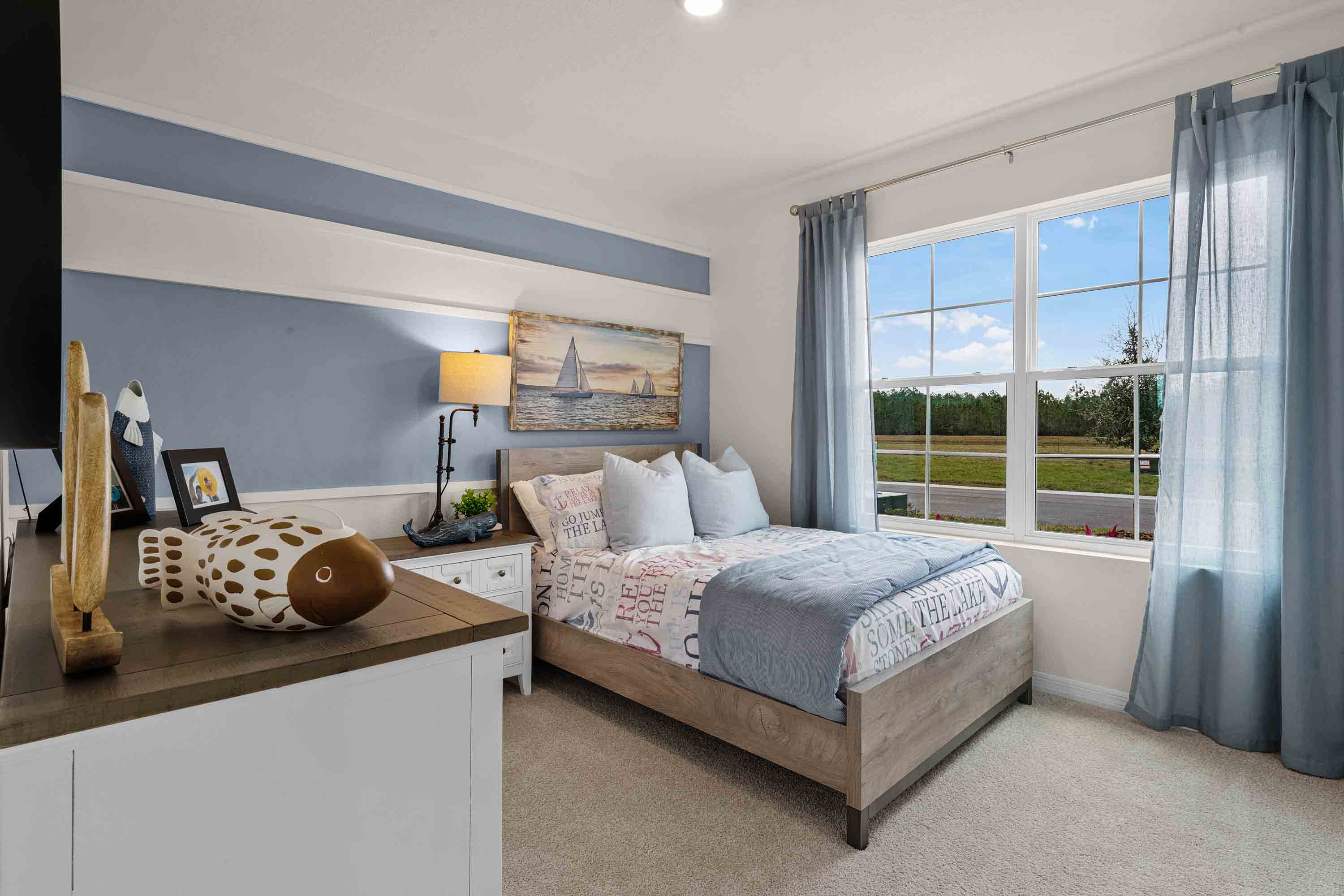 Guest bedroom with bed, nightstands and a roomy closet for storage.