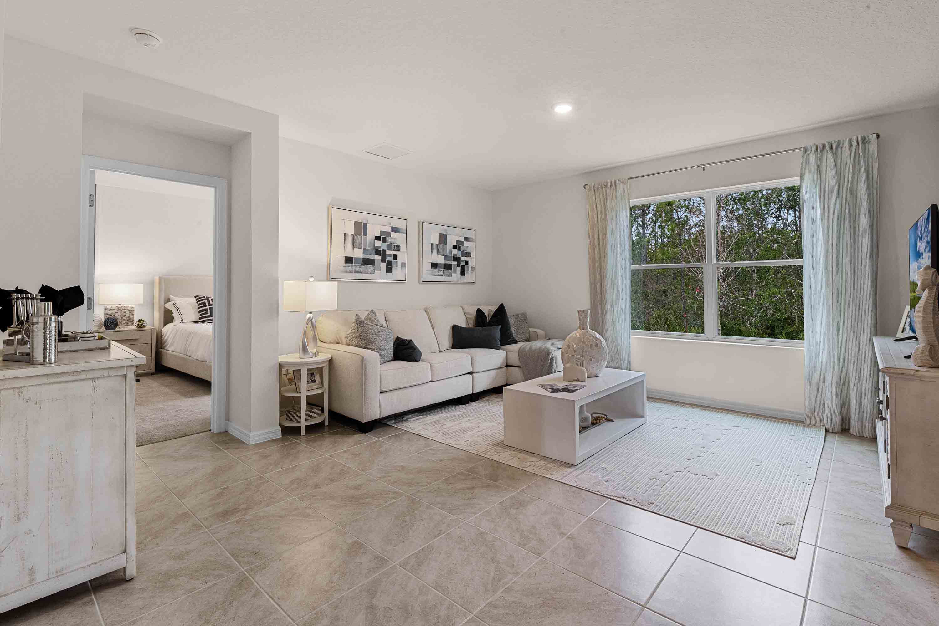 Open concept living area with couch seating and access to the backyard thru slider door.