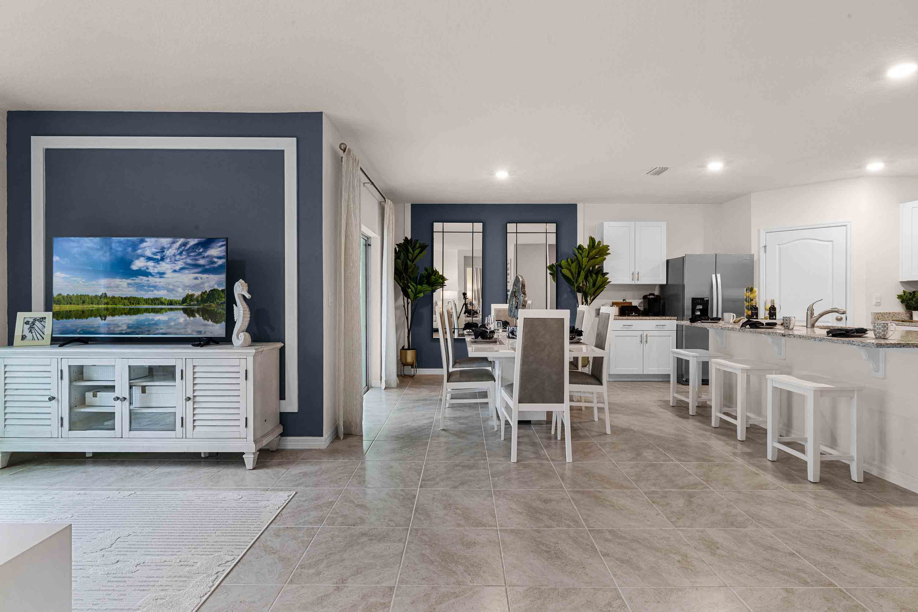 Open concept living area with couch seating and access to the backyard thru slider door.