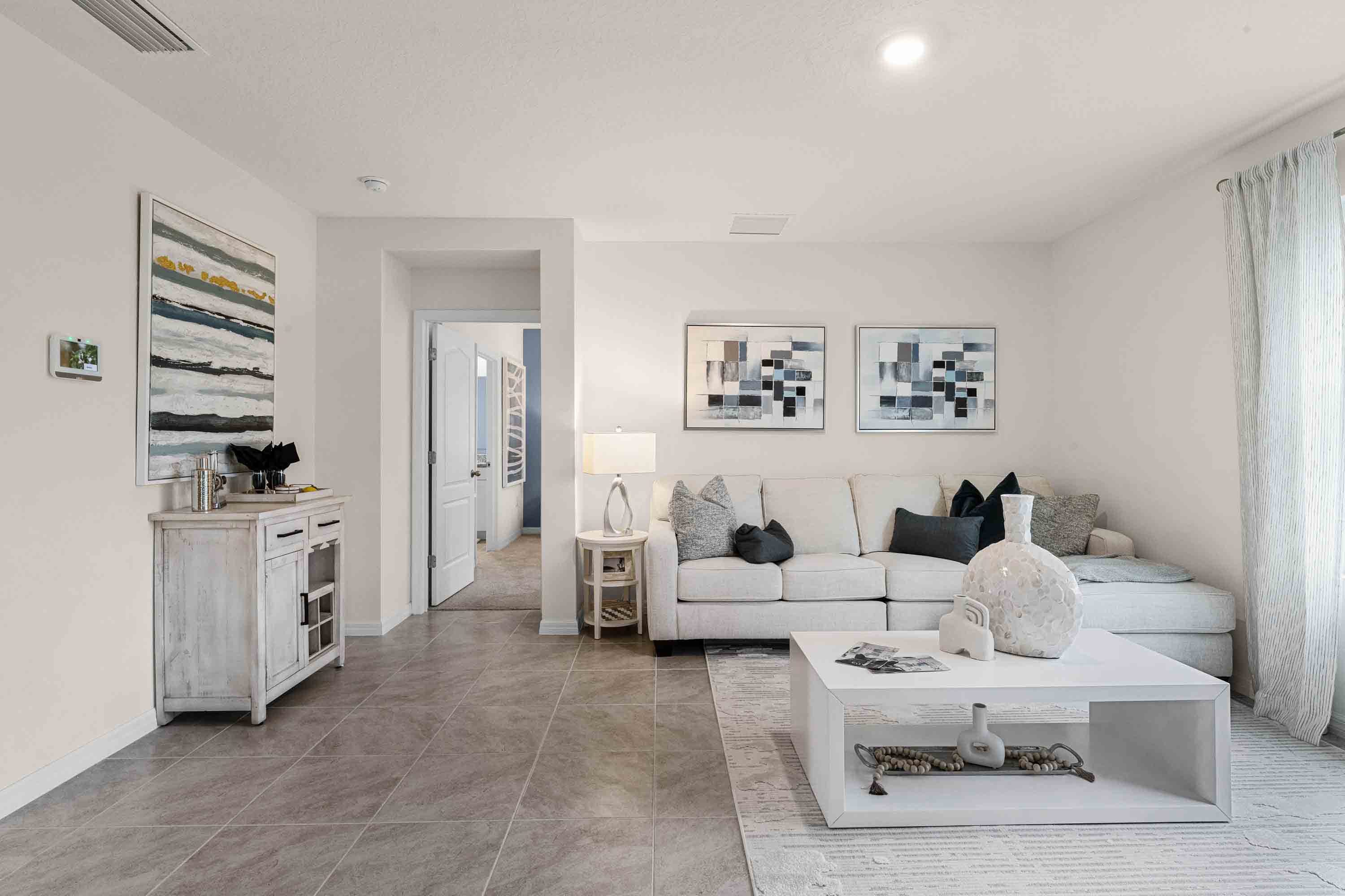 Open concept living area with couch seating and access to the backyard thru slider door.