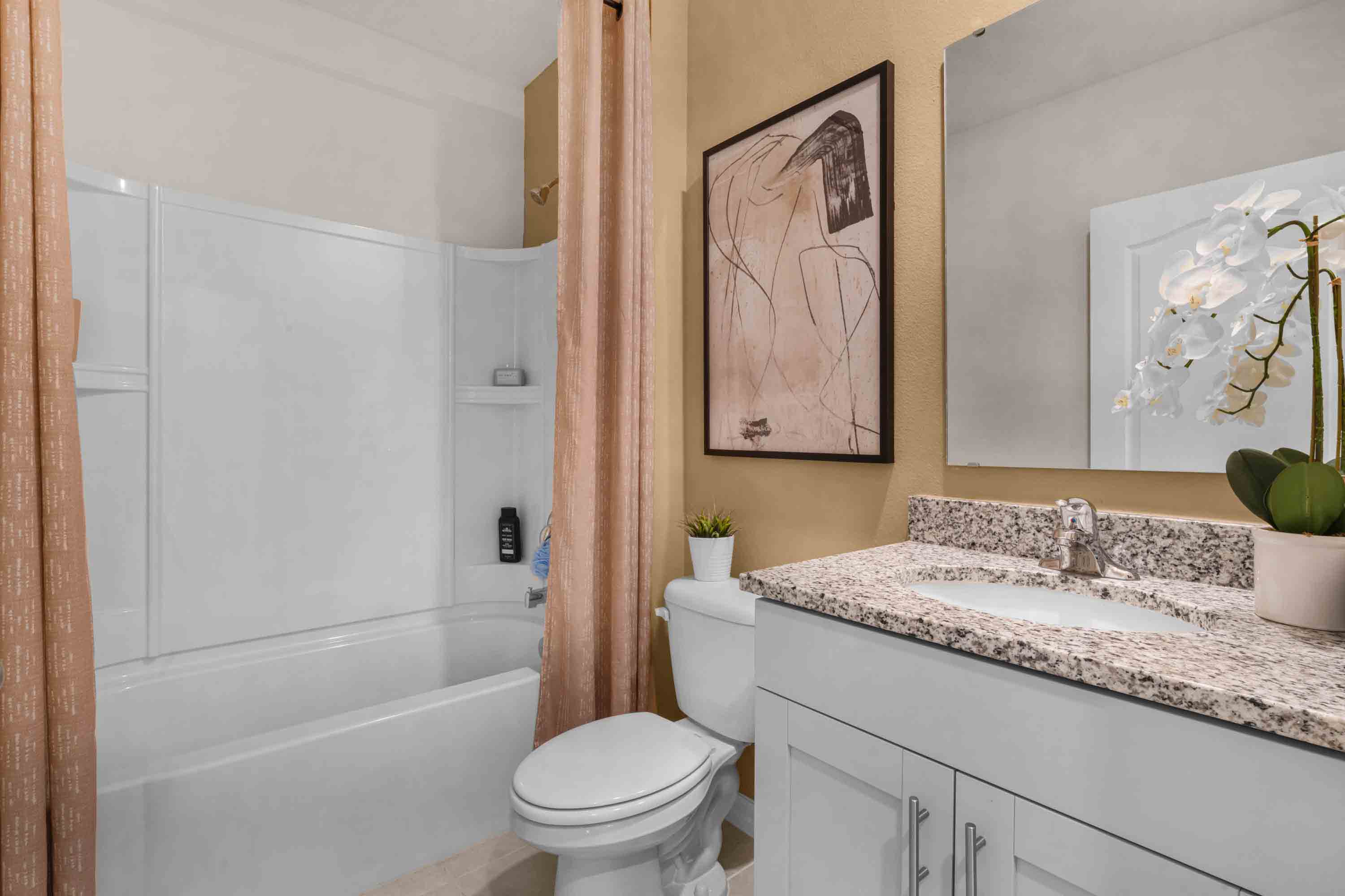 Bathroom with sink, counter space and walk in shower.