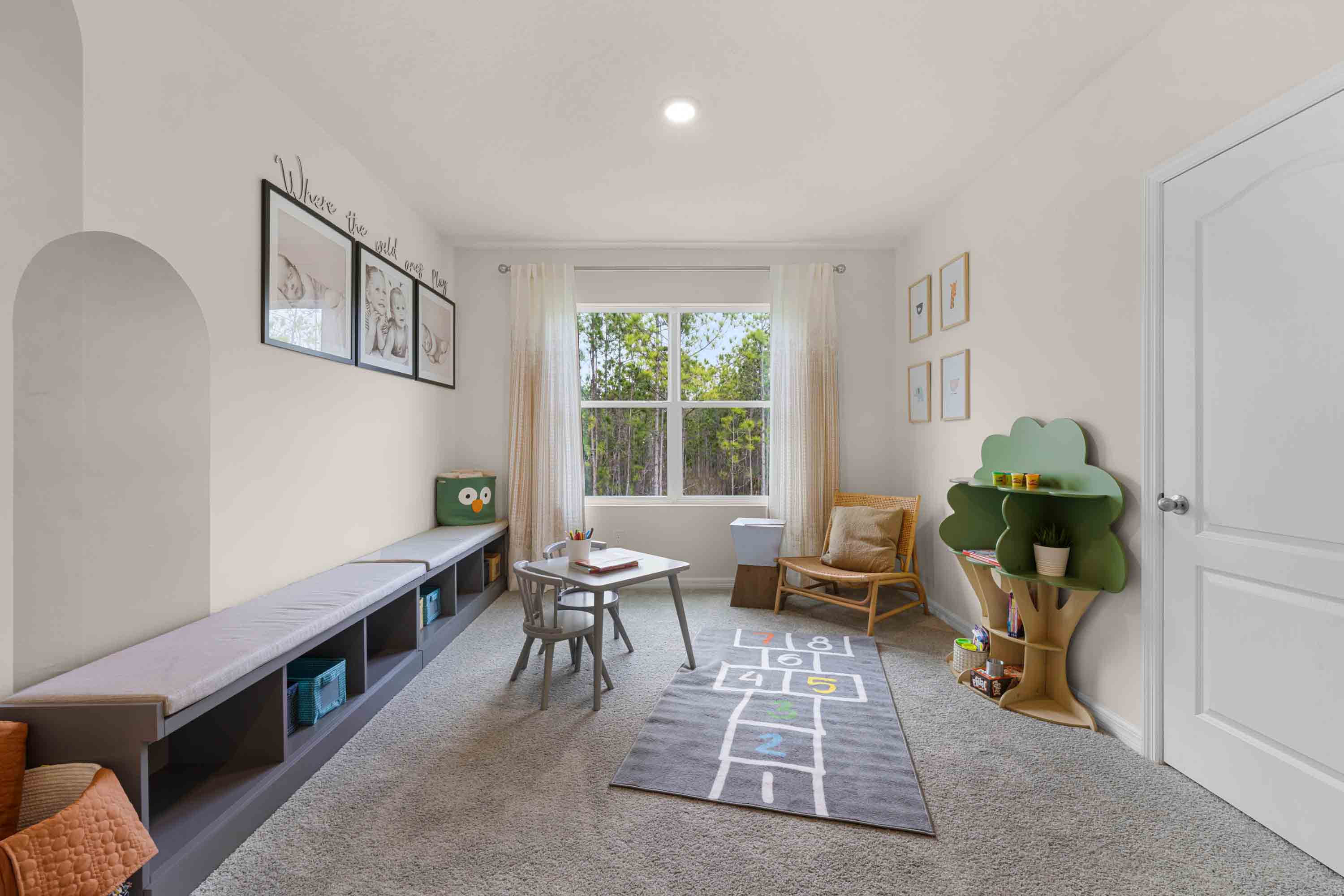 Child's nursery with crib, closet, soft seating and storage.