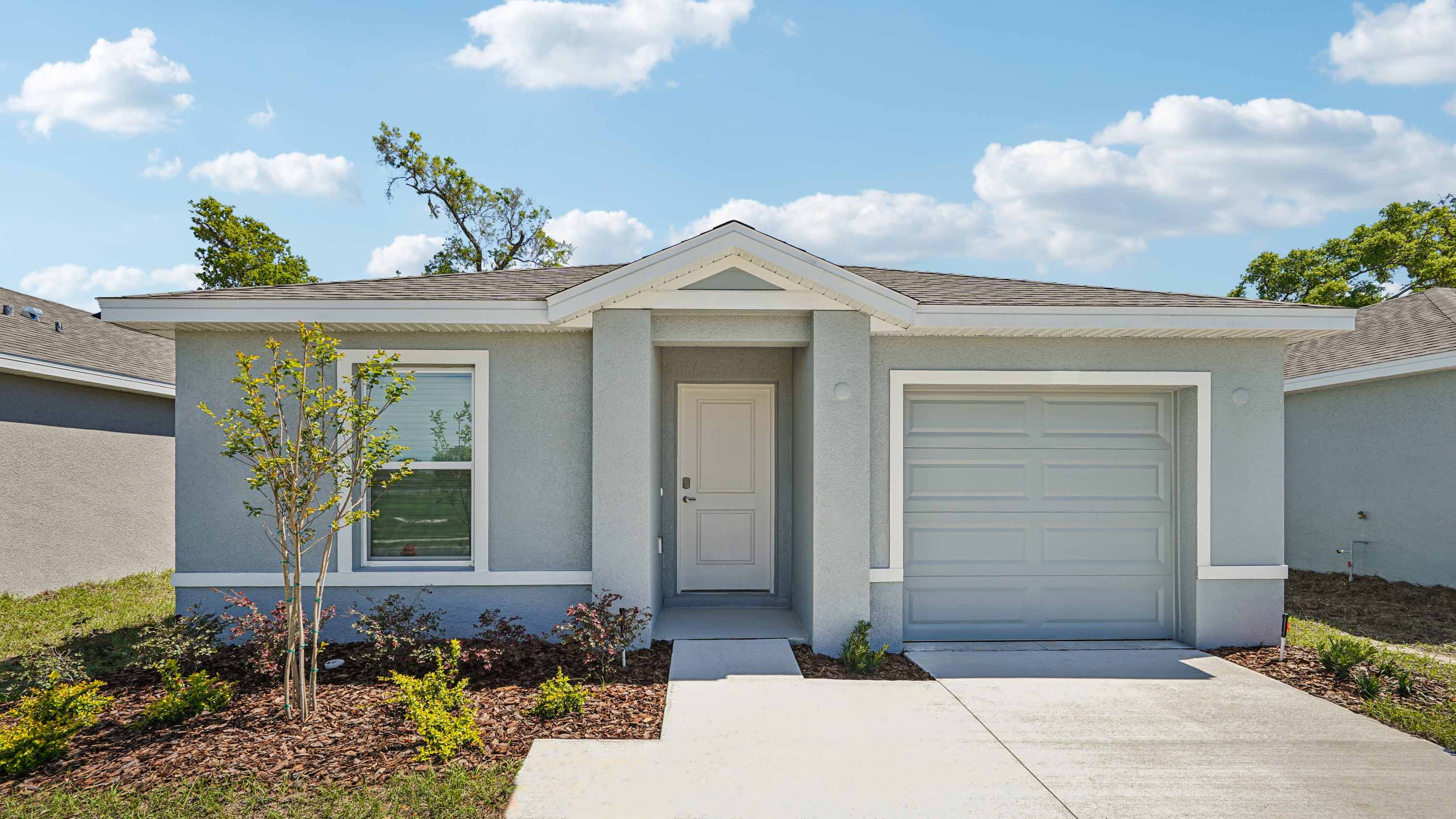 Single story new home with large windows and 2 car garage.