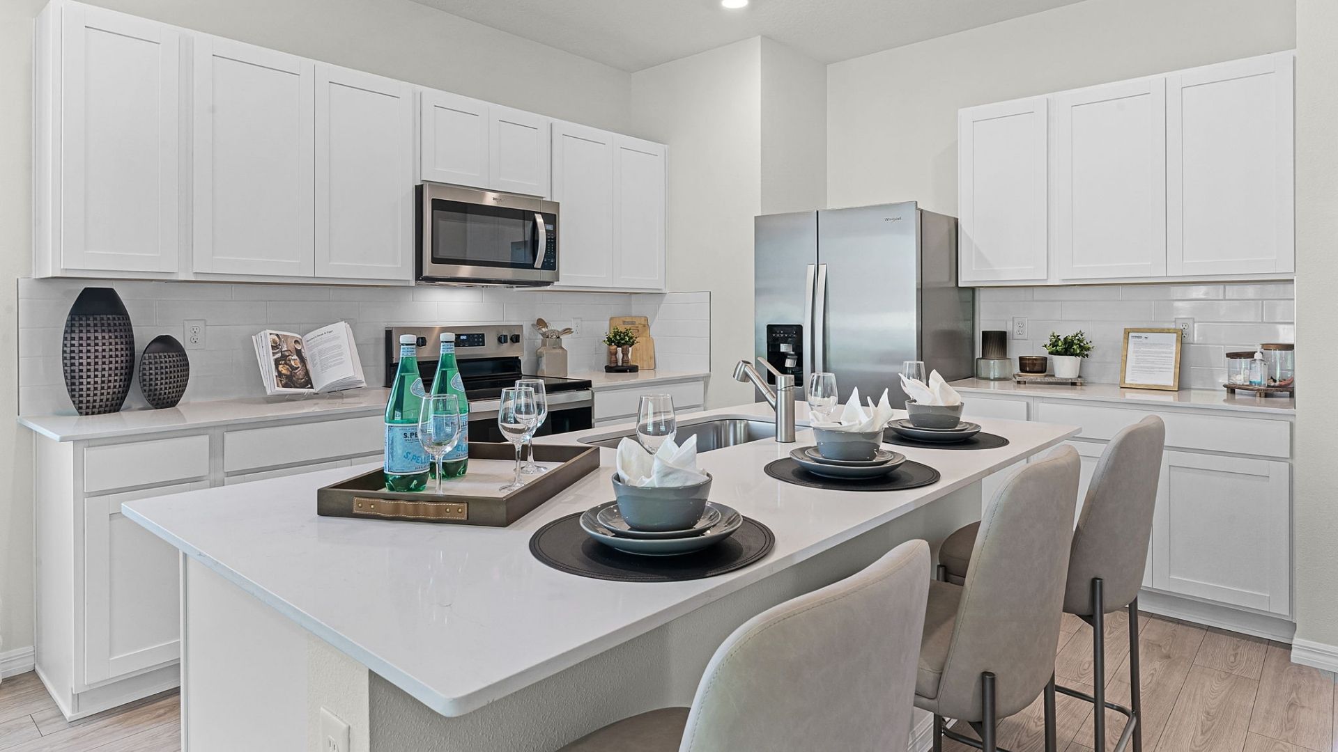 kitchen with quartz countertops overseeing living area and dining room table