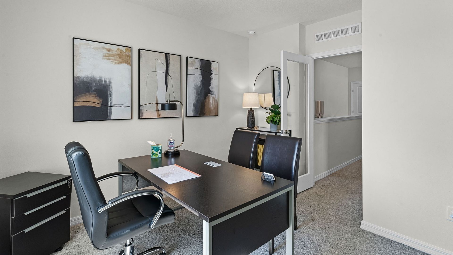 Functional home office with desk, chairs and space to work or play.