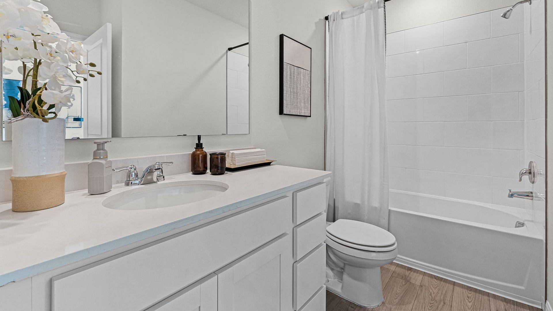 primary bathroom with quartz counters double sink and revwood select flooring