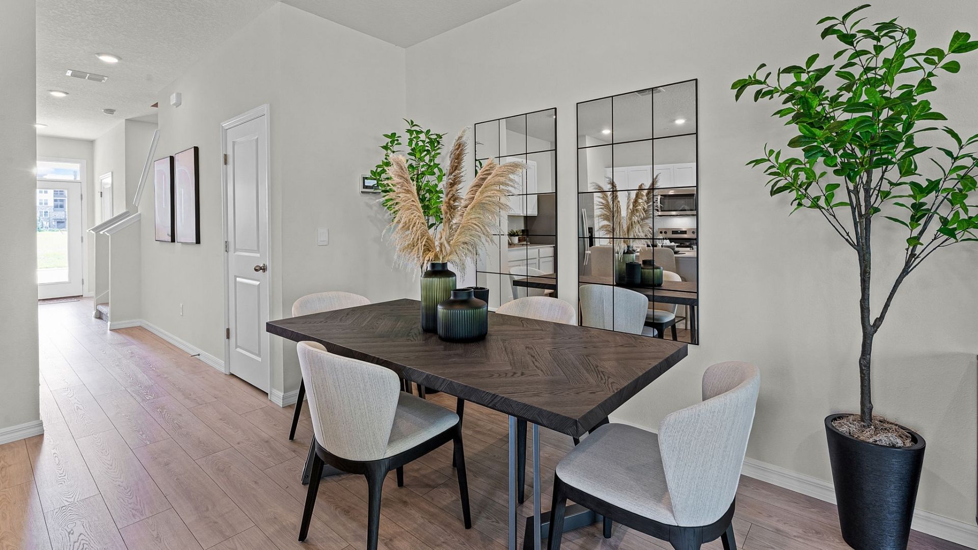 Dining room area with table, seating and natural lighting.