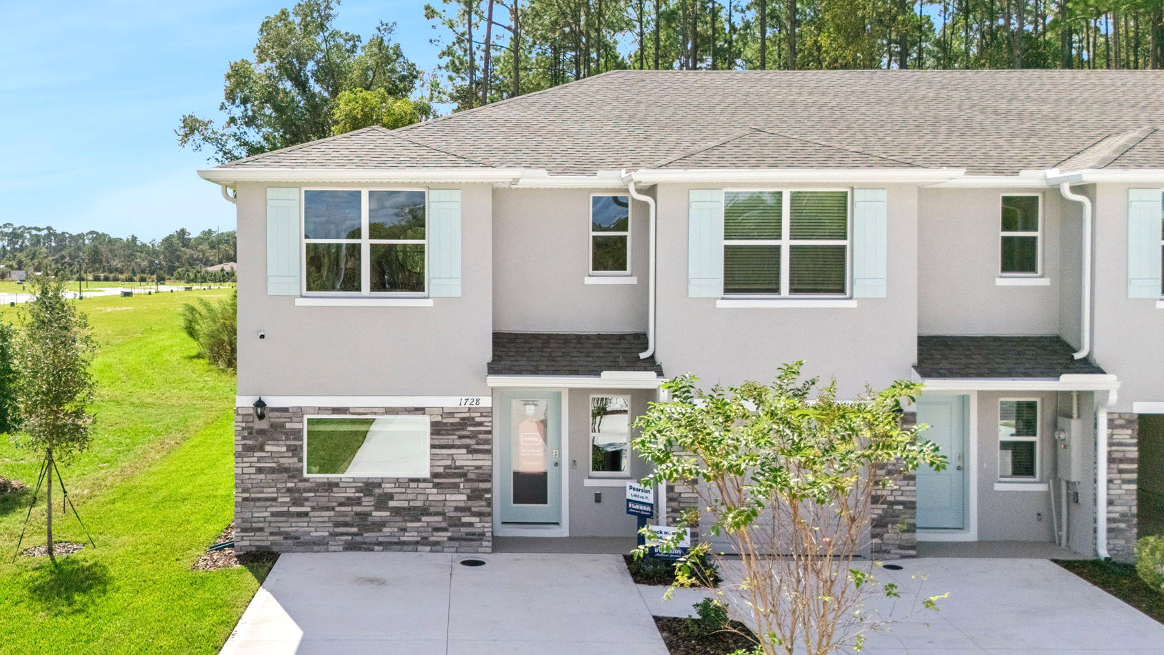Attached townhome with concrete block construction and a one-car garage.