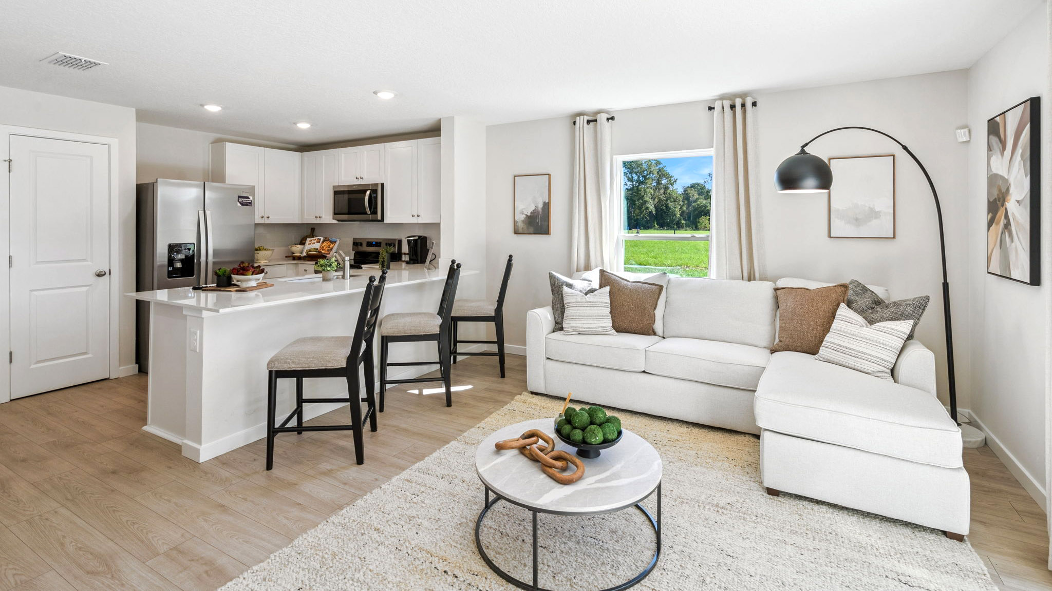 Living area with couch seating, entertainment system and natural lighting