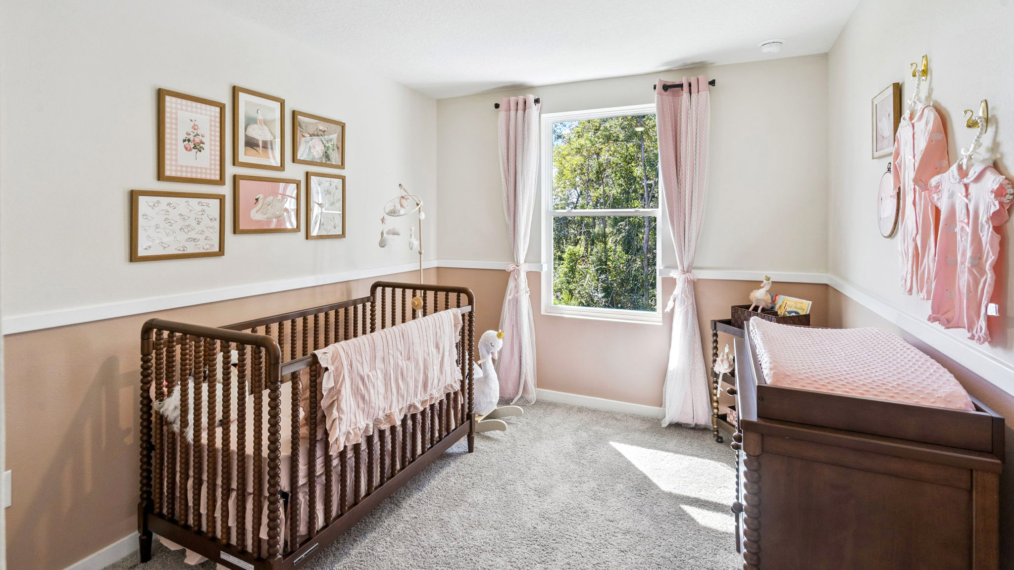 Spacious primary bedroom with king size bed, carpet flooring, natural lighting.